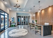 Thumbnail 2 of 15 - A modern lobby with a reception desk and chairs.