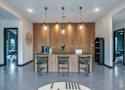 Thumbnail 1 of 15 - A modern office with a wooden panelled wall and a reception desk with four chairs.