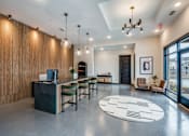 Thumbnail 8 of 15 - A modern office space with a reception desk and comfortable seating areas.