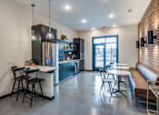 Thumbnail 9 of 15 - A modern kitchen with a bar area and a view of the outdoors.