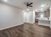Thumbnail 13 of 15 - A room with a ceiling fan and wooden flooring.