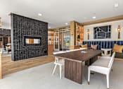 Thumbnail 5 of 26 - A modern living room with a fireplace and a dining table.