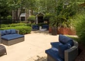 Thumbnail 6 of 17 - a patio with couches and chairs in a garden