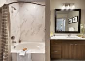 Thumbnail 6 of 17 - a bathroom with a bathtub and a sink