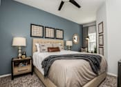Thumbnail 9 of 28 - a bedroom with a bed and a ceiling fan