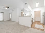 Thumbnail 18 of 41 - an empty living room and kitchen with white walls and wood flooring