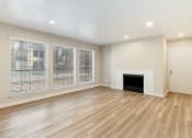 Thumbnail 5 of 28 - a living room with a fireplace and large windows