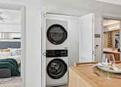 Thumbnail 4 of 26 - A modern laundry room with a washer and dryer built into the cabinetry.