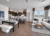 Thumbnail 8 of 36 - A modern kitchen with a dining table and chairs.