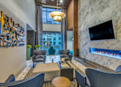 Thumbnail 8 of 26 - A modern living room with a television and a fireplace.