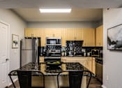 Thumbnail 4 of 28 - a kitchen with stainless steel appliances and a granite counter top