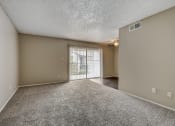 Thumbnail 14 of 26 - an empty living room with a sliding glass door