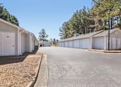 Thumbnail 13 of 31 - A row of white mobile homes with a clear blue sky above.