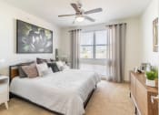 Thumbnail 14 of 33 - a bedroom with a large bed and a ceiling fan