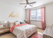 Thumbnail 13 of 33 - a bedroom with a bed and a ceiling fan