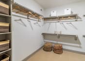 Thumbnail 12 of 33 - a spacious walk in closet with shelves and hangers
