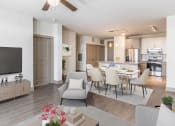 Thumbnail 10 of 33 - a living room and kitchen area with a dining table and chairs