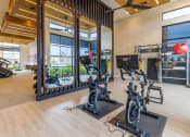 Thumbnail 30 of 33 - a room filled with lots of exercise equipment