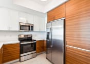 Thumbnail 63 of 66 - a kitchen with white cabinets and stainless steel appliances