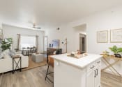 Thumbnail 1 of 26 - a living room with a kitchen and a dining room
