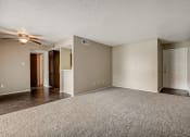 Thumbnail 12 of 26 - an empty living room with a ceiling fan