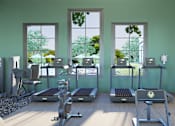 Thumbnail 29 of 37 - A gym with treadmills, exercise bikes, and other equipment.