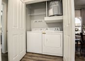Thumbnail 11 of 28 - a washer and dryer in a laundry room with a door open