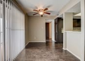 Thumbnail 13 of 26 - a living room with a ceiling fan and a large window