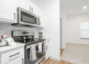 Thumbnail 22 of 41 - a kitchen with stainless steel appliances and a microwave