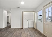 Thumbnail 22 of 43 - A white room with a washer and dryer in it.
