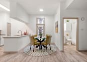Thumbnail 9 of 43 - A kitchen with a dining table and chairs in the middle.