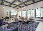Thumbnail 1 of 25 - A living room with a purple rug and a grey couch.