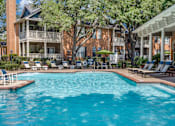 Thumbnail 18 of 25 - A large swimming pool in front of a building with a balcony.