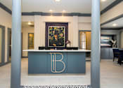 Thumbnail 11 of 25 - A reception desk with a gold letter B on it.
