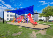 Thumbnail 36 of 36 - a playground with a blue canopy