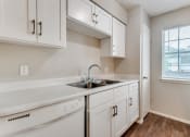 Thumbnail 5 of 16 - the preserve at ballantyne commons apartment kitchen with sink and white cabinets