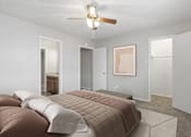 Thumbnail 7 of 22 - A bedroom with a bed and a ceiling fan.