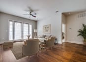 Thumbnail 3 of 42 - a living room with a couch and chairs and a ceiling fan
