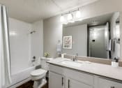 Thumbnail 11 of 20 - a bathroom with a sink toilet and a mirror