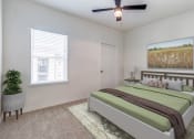 Thumbnail 11 of 65 - a bedroom with a bed and a ceiling fan