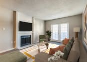 Thumbnail 5 of 20 - a living room with a couch and a table and a fireplace