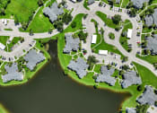 Thumbnail 6 of 41 - an aerial view of houses next to a body of water