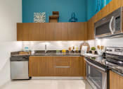 Thumbnail 2 of 25 - a kitchen with stainless steel appliances and wooden cabinets