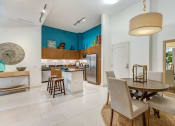 Thumbnail 4 of 25 - a kitchen and dining room with a table and chairs