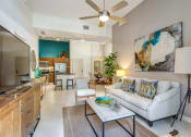Thumbnail 7 of 25 - a living room with a couch and a coffee table