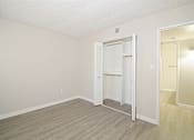 Thumbnail 10 of 28 - a bedroom with hardwood floors and white walls
