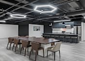 Thumbnail 6 of 35 - A modern dining area with a long table and chairs.