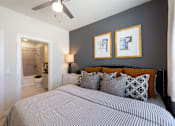 Thumbnail 9 of 33 - A bedroom with a large bed and two framed pictures on the wall.