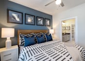 Thumbnail 10 of 33 - A bedroom with a large bed and a ceiling fan.
