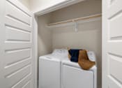 Thumbnail 12 of 33 - A small laundry room with a washer and dryer.